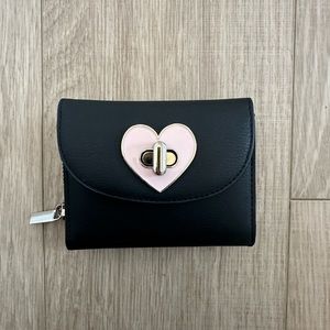 Black wallet with pink latch.